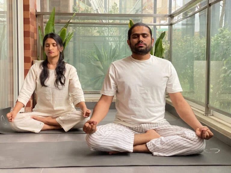 Yogacharya Manish and Yogini Pooja seated in meditation together